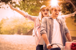 Hip young couple going for a bike ride on a sunny day in the city_11zon